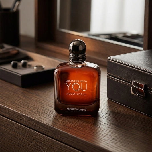 Emporio Armani Stronger With You Absolutely Parfum bottle on dark oak wood table lifestyle scene